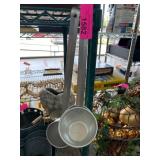 Two Metal Measuring Cups on Hooks