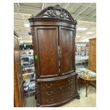 Wooden Armoire With Carved Details and Drawers