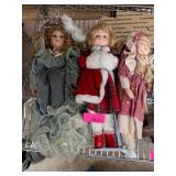 Three Porcelain Dolls with Various Attires