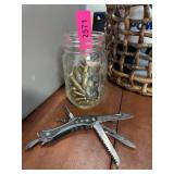 Jar of Brass Cartridges and Multi-Tool Knife