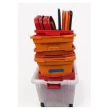 Stack of Orange and Clear Plastic Storage Bln
