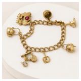 Gold Tone Charm Bracelet with Assorted Charms