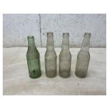 Group Of Five Embossed Glass Beverage Bottles