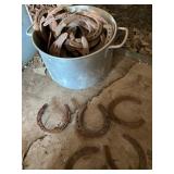 Metal Pot Containing Assorted Rusted Horseshoes