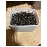 Large Quantity of Black Screws in Plastic Bin