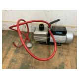 Vacuum Pump with Red Hose and Gauge