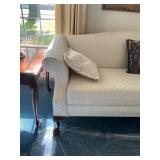 Upholstered Camelback Sofa With Carved Wood Legs