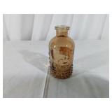 Amber-Colored Embossed Glass Bottle