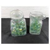Two Glass Jars of Green-Toned Marbles