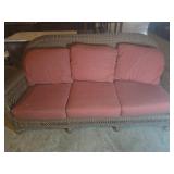 Brown Wicker Sofa with Red Cushions