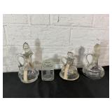 Four Clear Glass Containers with Stoppers