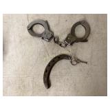 Metal Handcuffs with Key and Rusted Horseshoe