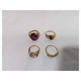 Four Gold-Tone Rings with Stones