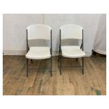 2 White Plastic Folding Chairs