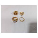 Four Gold-Tone Rings With Stones