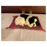 Black and White Plush Dog Toy on Cushion