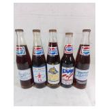 Five Pepsi Commemorative Glass Bottles