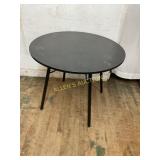Round Black Metal Table with Four Legs