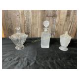 Three Decorative Glass Containers and Lids