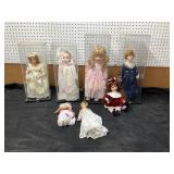 7 Porcelain Dolls with Stands and Cases includes 2