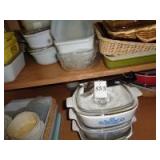 Lower cabinet containing Corning Ware, baking dishes