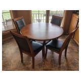 Round Wooden Dining Table with Four Upholstered Chairs
