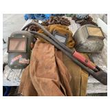 Assorted Welding Gear Lot Including Helmets, Jackets, and Electrode Holders