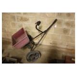 Lawn spreader with extended wheels