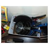 box full of pots and pans