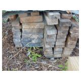 Stack of asst lumber-south side of open shed