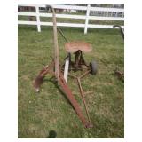 rusty pull behind rubber tire mounted seat