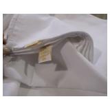 White flat sheets and assorted color cloth napkins