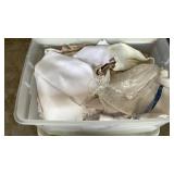 2 tubs of table cloths, doilies, etc