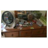 Sewing box, dice, table fan, marbles all on top