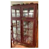 Cabinet with glass shelves and mirrored back, has