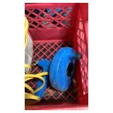 Milk crate with electrical wire and drain snake