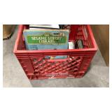 Milk crate, books, cassettes, dvd