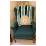 Wingback chair, pillow and afghan