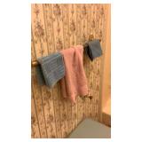 Contents of bathroom: clothes hamper, towel, hand