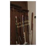 Items on wall by house entry door Rakes & misc.