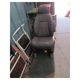 Gray Vehicle Seat with Headrest and Carpet Base