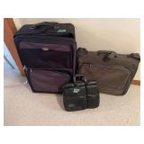 Assorted Luggage Grouping Including Rolling Suitcases and a Dell Briefcase