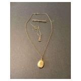 Collection of Gold Jewelry Including Locket, Eiffel Tower Pendant, and Bar Brooch
