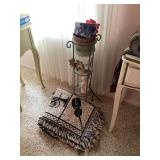 Metal Plant Stand with Figurines and Assorted Textiles