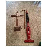 Assorted Household Items Including Dirt Devil Vacuum, Wooden Cane, and Decorative Cross
