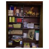 Assorted Craft Supplies, Storage Baskets, and Decorative Items on Wooden Shelving Unit