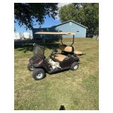 EZ-GO Electric Golf Car with Rear Cargo Seat and Tan Canopy
