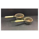 2 wooden handled cast iron pans