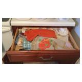 Drawer full of towels, potholders and dish cloths