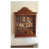 Hanging curio cabinet with contents
